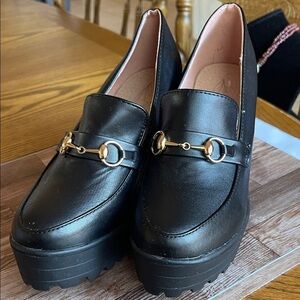 Chic Black Loafers with Gold Accents